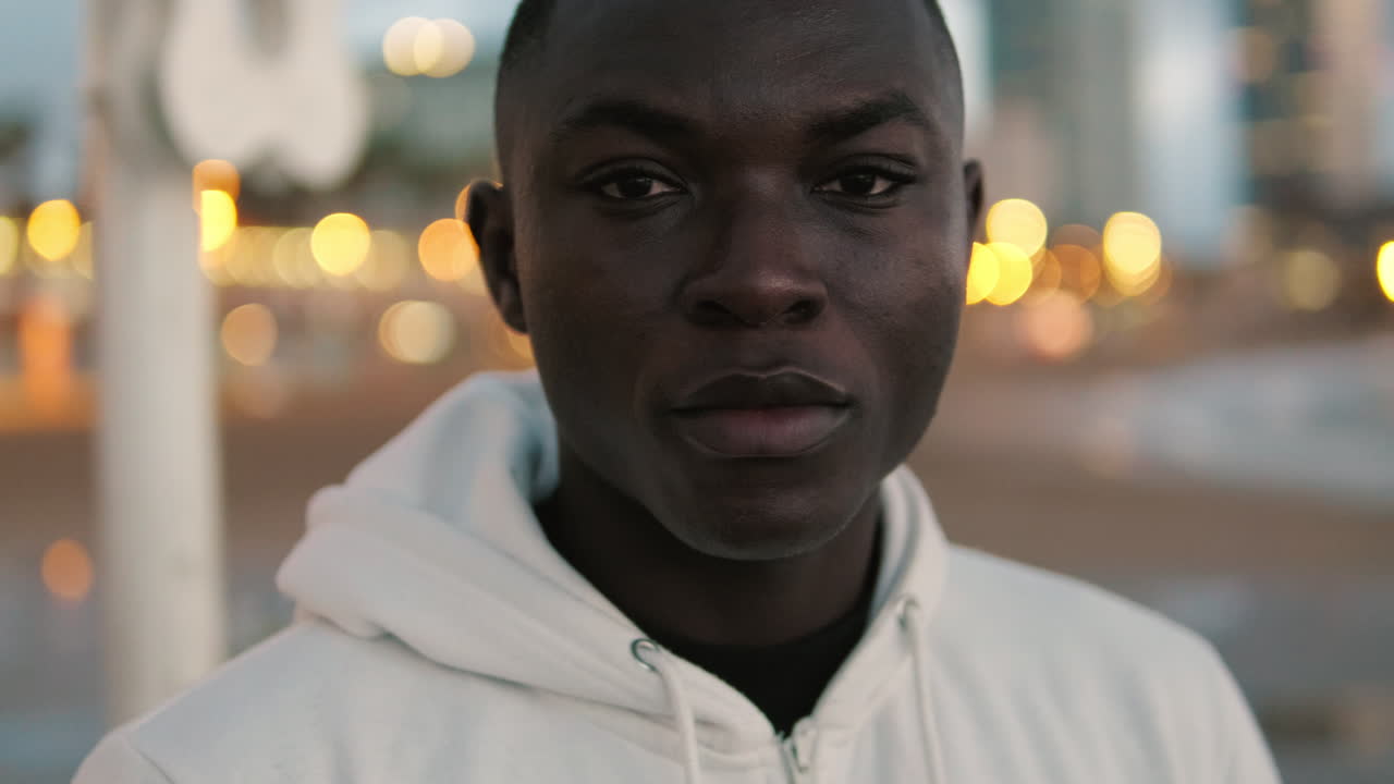 Close-up Portrait of a Young Black Man Looking at Camera at Night