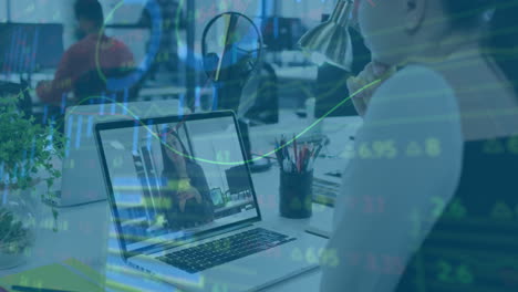 In office, person video calling on laptop with financial data animation displayed