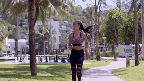 Asian-cheerful-woman-running-in-park