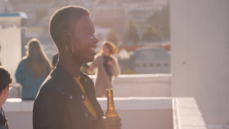 group-of-multi-ethnic-friends-hanging-out-enjoying-rooftop-party-chatting-drinking-alcohol-having-fun-socializing-on-weekend-reunion-celebration-at-sunset