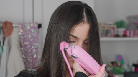 beautiful teenage girl vlogger filming makeup tutorial sharing beauty video enjoying social media influencer recording hair straightening vlog at home