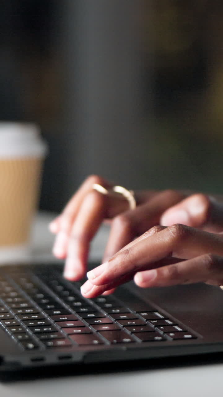 Close-up of Hands Typing on a Laptop Keyboard
