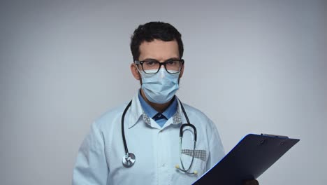 doctor says no, disagreement, stop. frightened worried man doctor on white background looking at camera and starts waving his hands nervously, shouting no-no-no