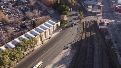 A-dynamic-aerial-shot-of-the-railroad-located-in-the-barrio-or-neighborhood-of-Chacarita-in-the-north-central-part-of-Buenos-Aires,-Argentina