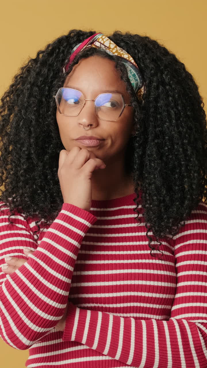 Pensive Young African American Woman with Glasses Thinking