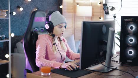 slow motion shot of a young girl getting annoyed while playing online games on her computer