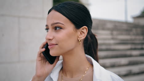 closeup smiling girl calling phone at staircase. happy woman talking smartphone