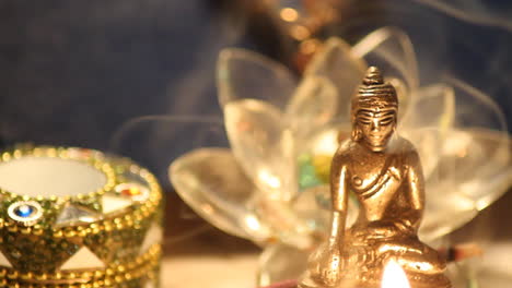 buddha statue with candle lights and incense smoke close up 12