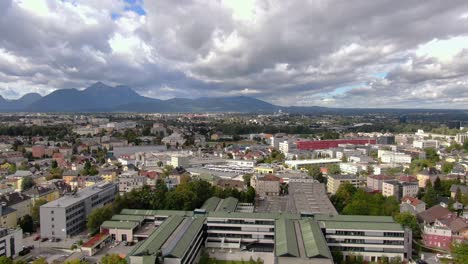 aerial rise showing skyline and alps of city kuchl near salzburg in austria