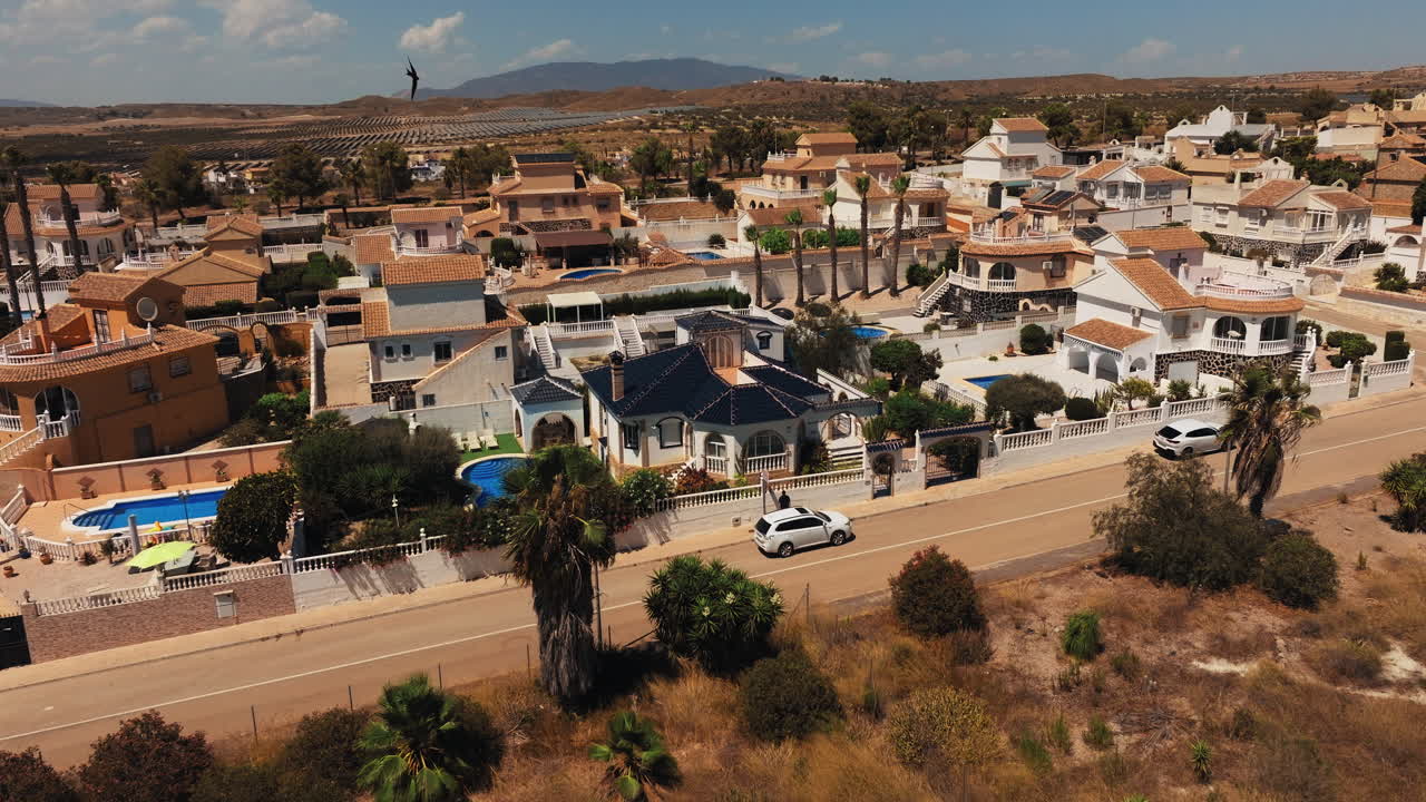 Sunny day views of luxury villas in southern Spain. Perfect vacation homes in a calm, Mediterranean setting, offering relaxation and elegance by the coast