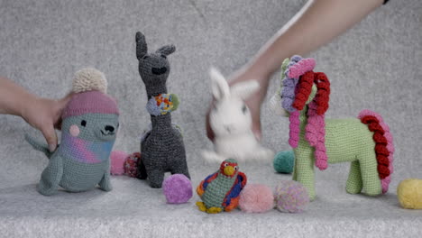 handmade knitted teddy bears and different animals, against grey background