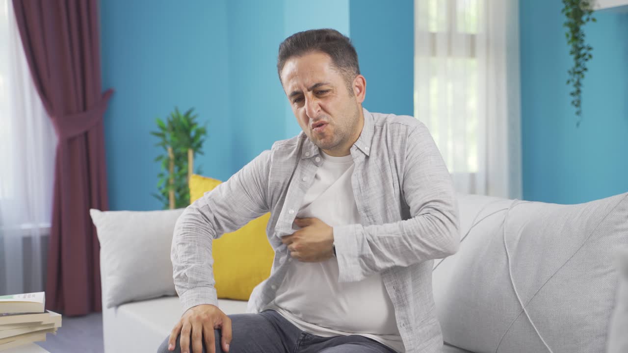 The man looking at the camera is itching.