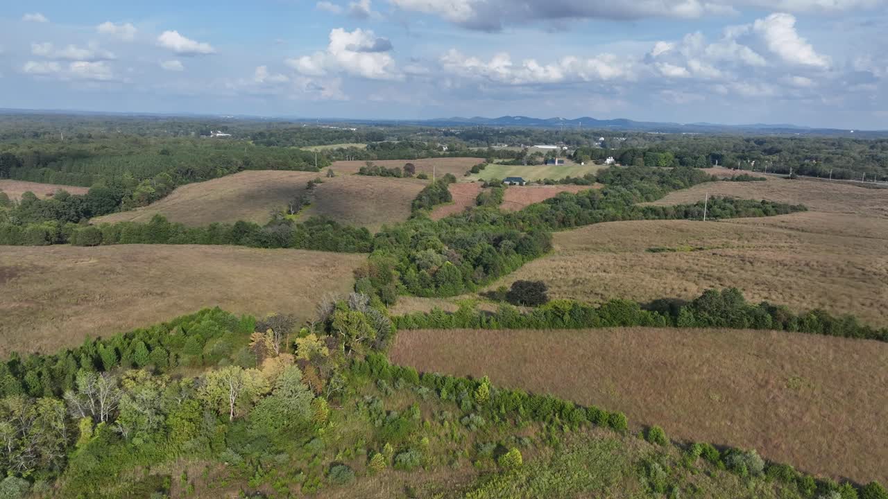 Hilly forest landscape on sunny day in late summer season. Rural area of American countryside. Peaceful scene . Aerial wide shot