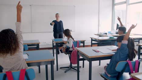 female teacher asking questions to pupils