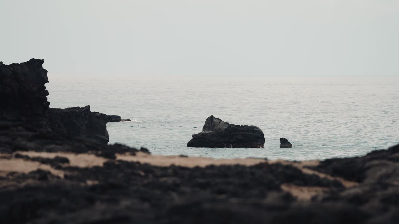 Volcanic rock coastline with blue ocean waves and sea views 4k60p