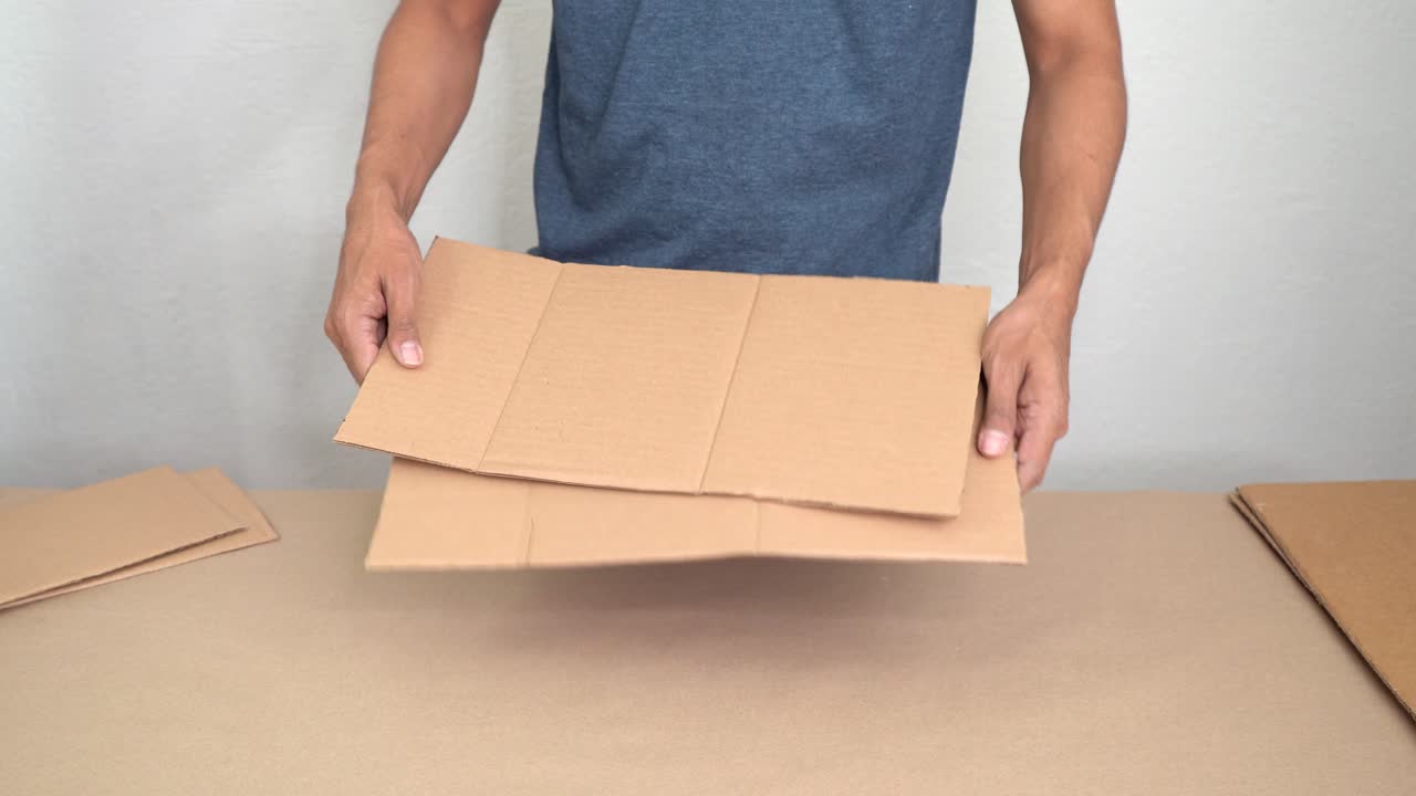 Hands crafting with cardboard, creative DIY process in calm setting