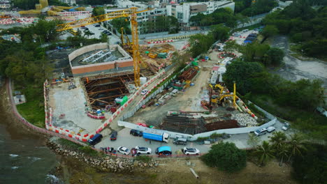 great drone static shot overlooking a construction site close to a shore