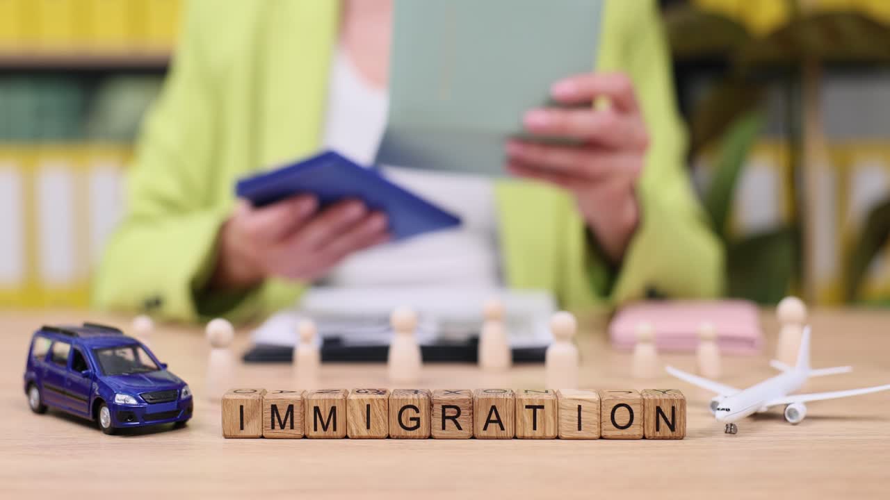 Immigration concept with wooden blocks and travel symbols