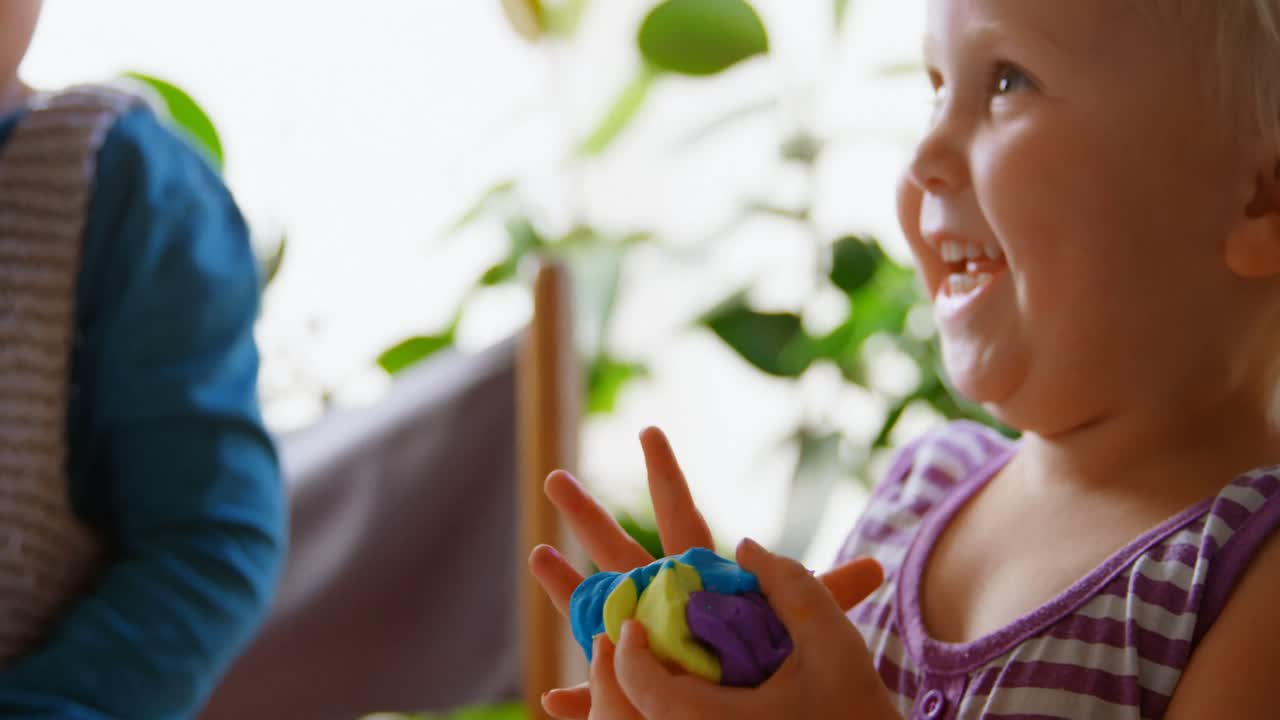 Premium Stock Video - Kids Playing With Clay In A Comfortable Home 4k