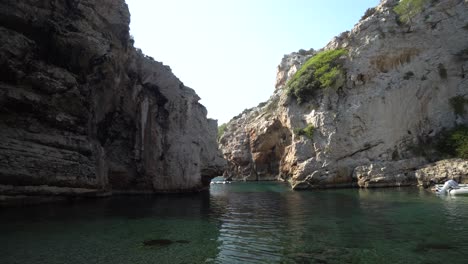 stunning hidden lagoon secluded by tall cliffs that hide it from the open ocean