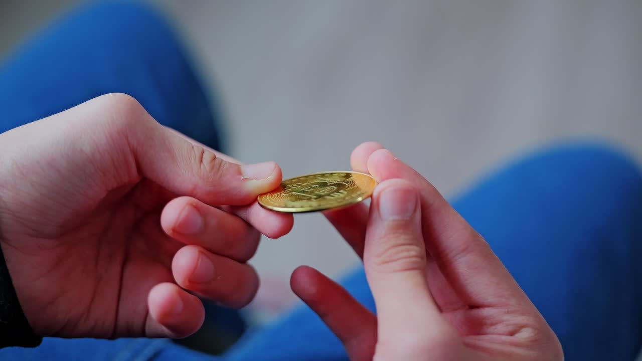 Curious child studying Bitcoin coin in hand symbolizing future business mindset