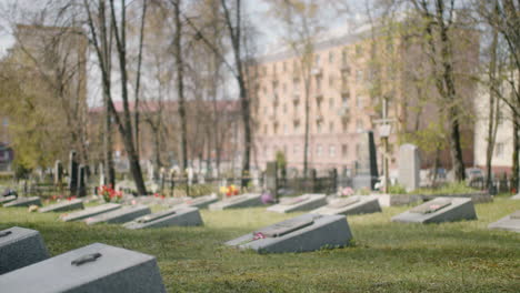 zoom in of a graveyard with tombstones in an urban area on a sunny day 1