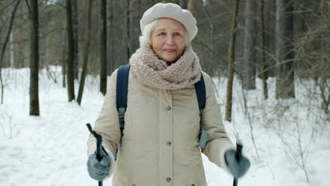 senior woman hiking in winter forest