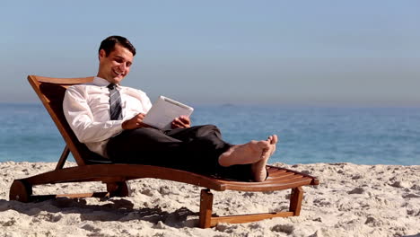 businessman lying on the beach