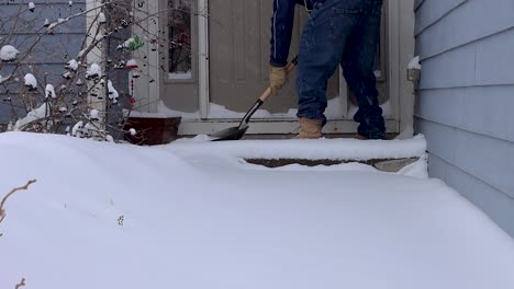 Clearing-snow-from-the-porch-to-make-guests-welcome-and-deliveries-safe