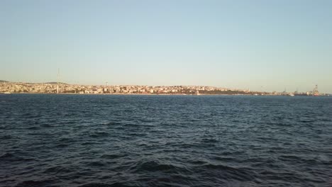 Evening,-cinematic-slow-mo,-the-view-of-Istanbul-Camlica-from-a-ferry-sailing-along-the-Bosphorus