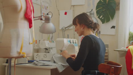 female dressmaker using sewing machine at work