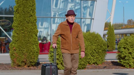 senior grandfather tourist go to international airport terminal for boarding on plane for traveling