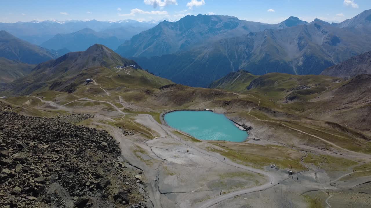 Beautiful high-altitude view overlooking Tyrolean peaks and a tranquil alpine lake near Ischgl