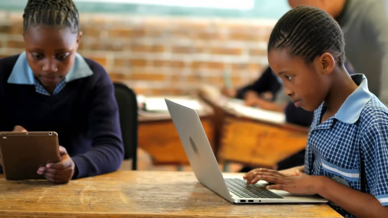 Students using laptop and digital tablet in classroom 4k