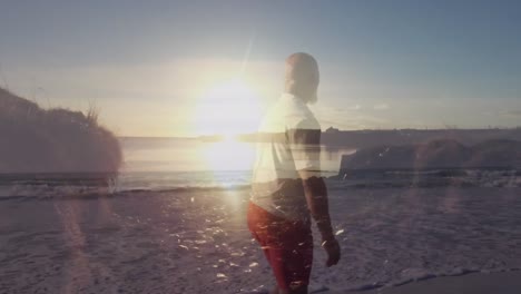 Animation-of-senior-african-american-man-walking-at-beach-over-landscape