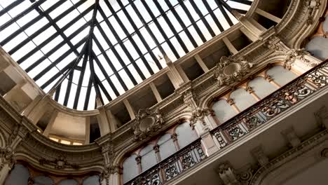 rotating shot of decadent italian hall with detailed crown molding and focus on skylight