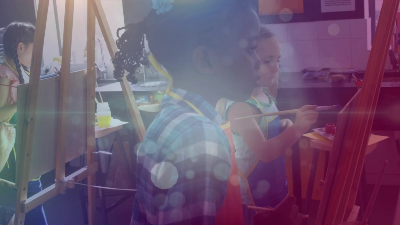 White spots of light floating against african american girl painting at elementary school
