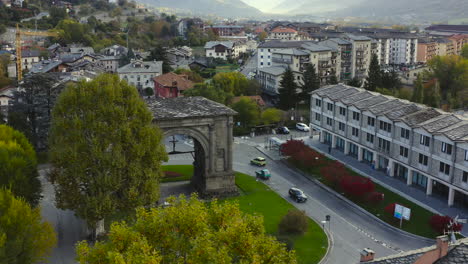 A-mesmerizing-view-of-the-Valle-d’Aosta,-with-the-amazing-Arch-of-Augustus,-a-monument-in-the-city-of-Aosta,-northern-Italy,-A-Drone-view