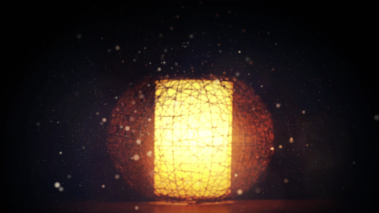 Animated flying shiny particles on a blurred yellow glowing table vintage lamp with a decorative lampshade on the table. Looped motion graphics.