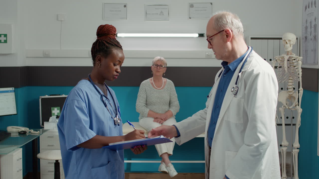 Doctor and african american nurse talking about patient diagnosis