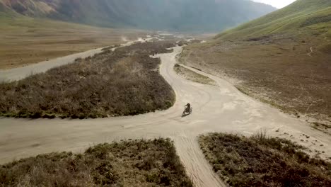 Drone-shot-of-a-crossbike-around-Bromo-volcano-in-Indonesia