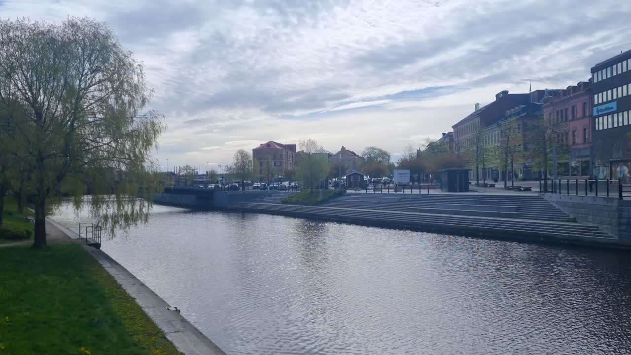 View of the Selångersån River in Sundsvall, Västernorrland County, Sweden, on a partly cloudy spring day, the water is slowly moving towards the Baltic sea