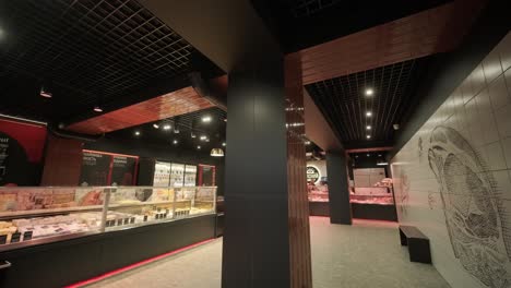 a meat shop specializing in fresh products. the scene shows neatly arranged meat on display counters, showcasing high-quality cuts in a clean and professional retail environment