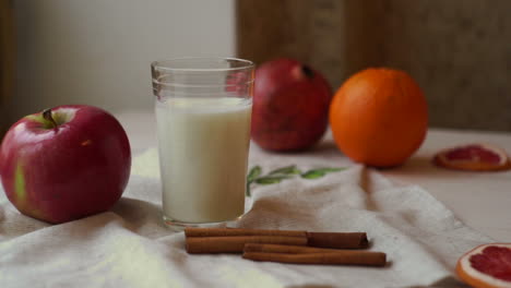 fruits and milk glass on kitchen table. healthy breakfast. fresh apple