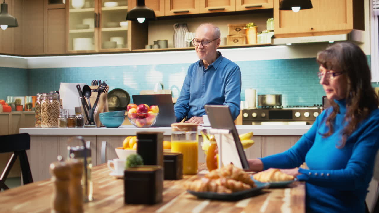 Mature pensioner enjoys happy video conference with family on his laptop