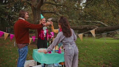 friends celebrating a birthday in a park
