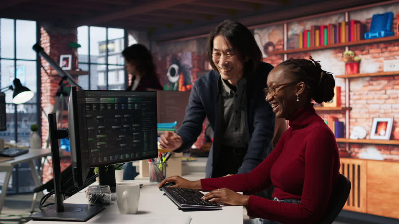 Senior team leader assisting worker in AI software development agency