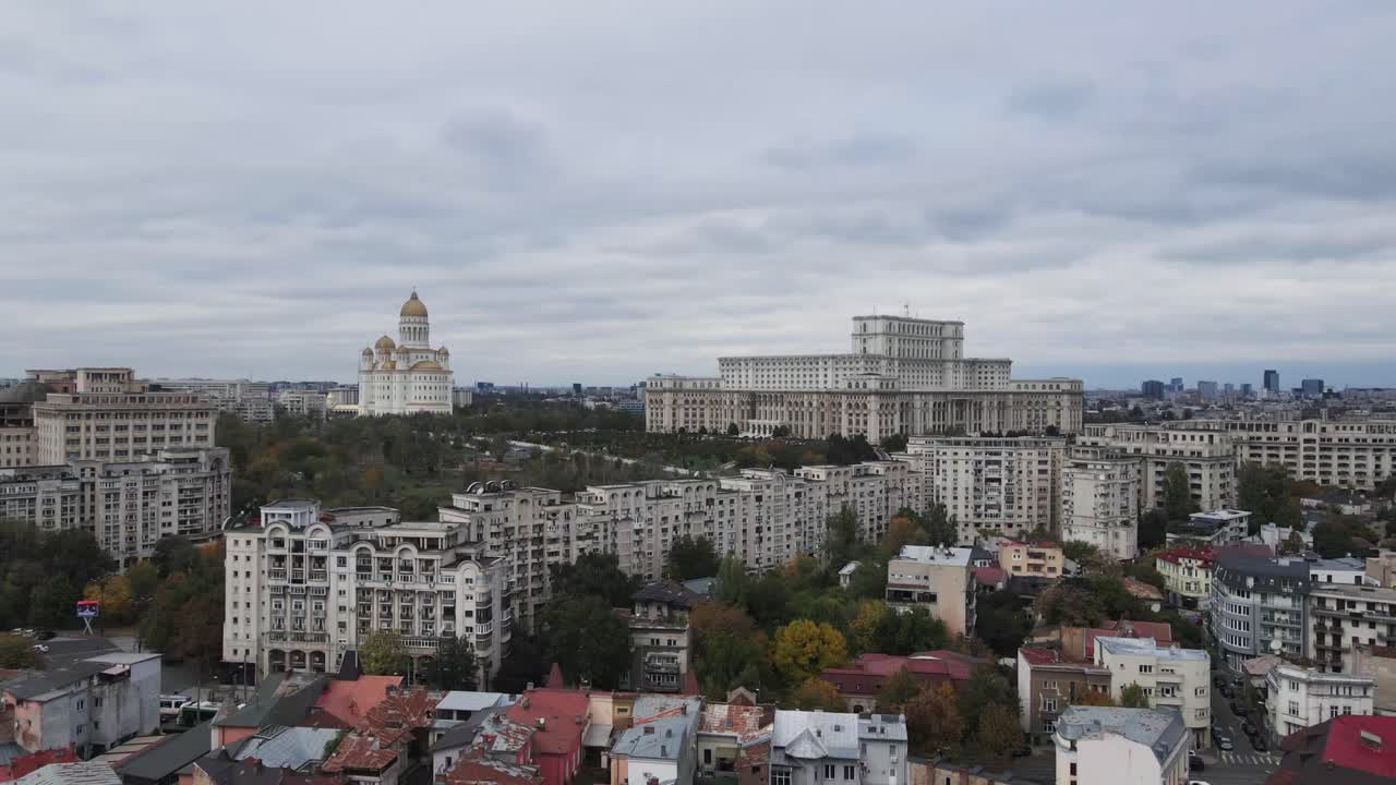 Aerial drone shot moving towards the Palace of the Parliament, also called the People's Palace in Bucharest, Romania