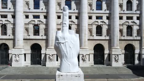 italy , milan july 2020 - drone  aerial view of borsa money exchange -finish lockdown due covid-19 coronavirus, street empty of tourist - piazza affari and new skyline and skyscrapers in downtown - dito medio statue by maurizio cattelan