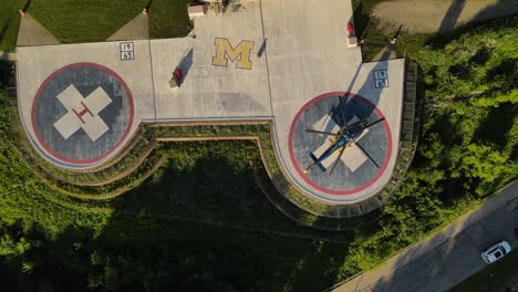 double landing pad with single helicopter near michigan university hospital, aerial view